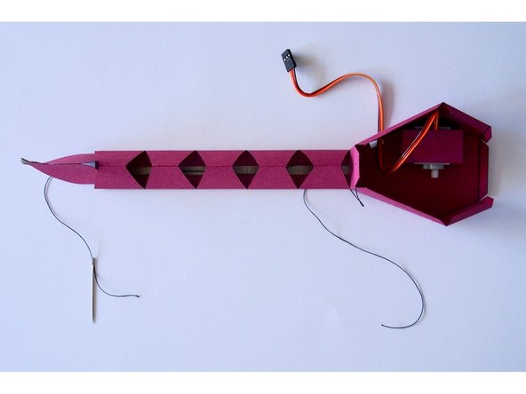 Cut a piece of string a bit longer than the tail, and thread it all the way through.