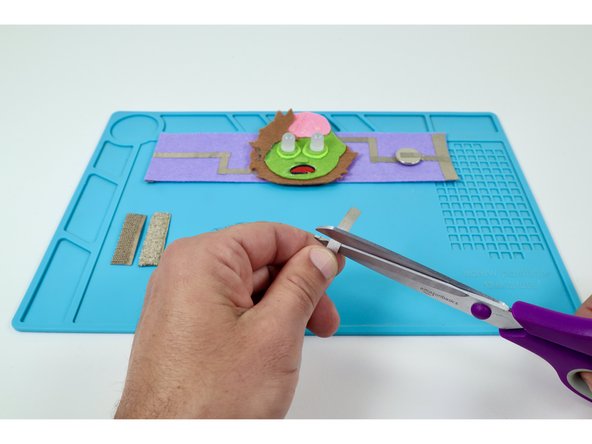 Cut two small pieces of Maker Tape that you will use to create tape loops. These tape loops are involved in the conductive  hook and loop closure system.