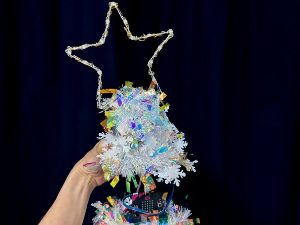 Wrap the garland around the cup and tape it in place.