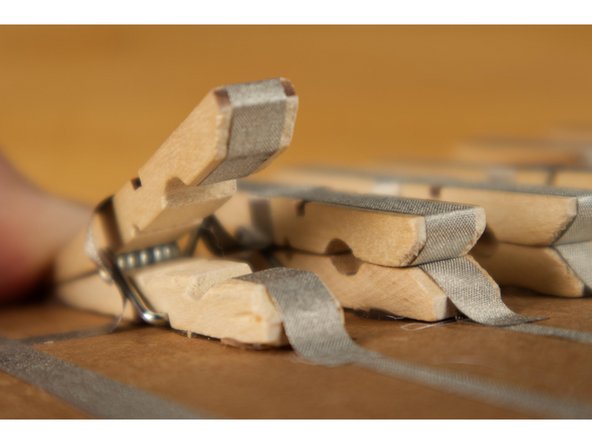 Add 1/4&quot; Maker Tape to the top and bottom pieces of each clothespin. The top pieces will all connect to ground, and the bottom pieces will each connect to a pin on the Bit Board.