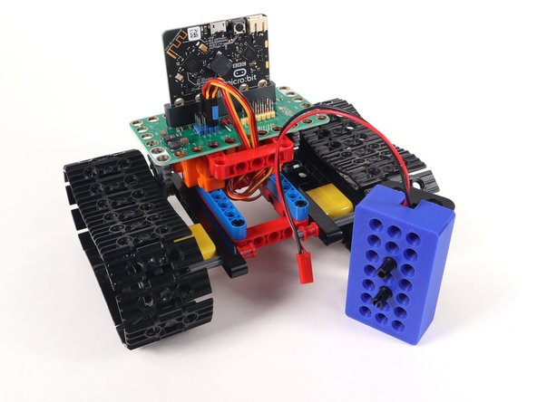 The battery holder will attach to the top frame piece sideways, as shown.