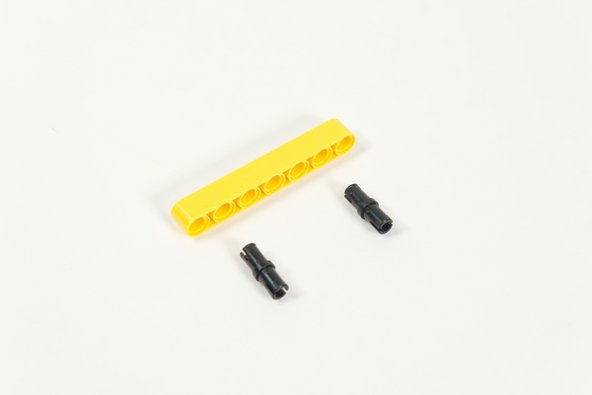 Add two black pins to the yellow 7 hole beam.