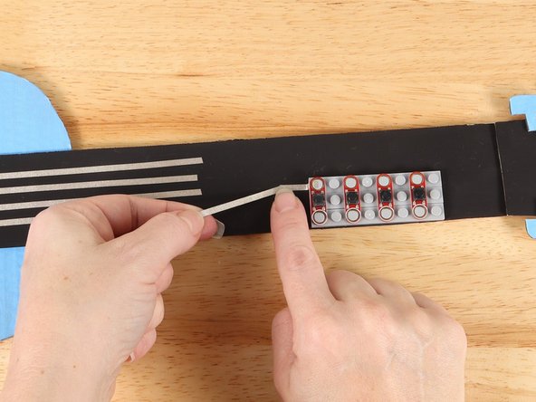 Add another piece of Maker Tape to connect the path diagonally from the button to the path from Pin 15.