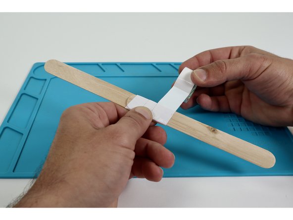 Use masking tape and join your two jumbo craft sticks to effectively create one long handle.