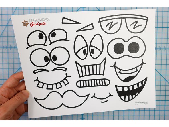 Choose funny face features from the template and color in the ones you pick, then cut them out.