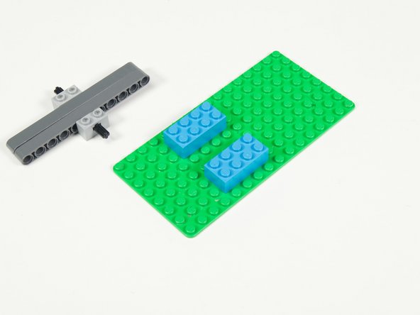 Add two 2 x 4 bricks to a baseplate. (If using a small baseplate make note of the position so you can fit the whole mechanism.)