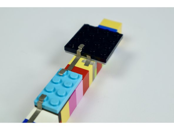 Starting with photo 1 and ending with the photos in the next guide step, measure, cut peel and stick the remaining 4 tape paths where shown.