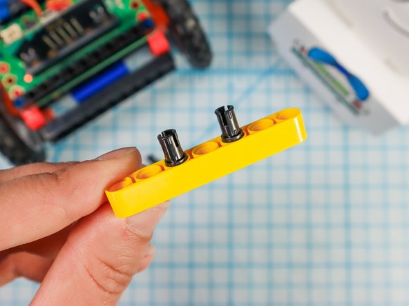 Use two pins to add a LEGO beam to the front of the Rover as shown.