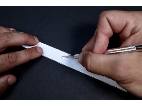 Fold the shape in half as shown on the dotted line that crosses the middle slot.