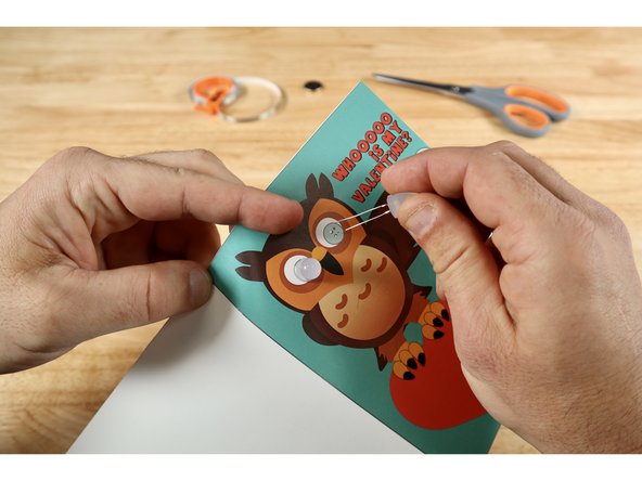 From the cover side: Thread the legs of each LED through a pair of vertically oriented holes. Note: Orientation of the legs matters! The longer Positive (+) Legs should go through the UPPER holes while the shorter Negative (-) Legs  should go through the lower holes.