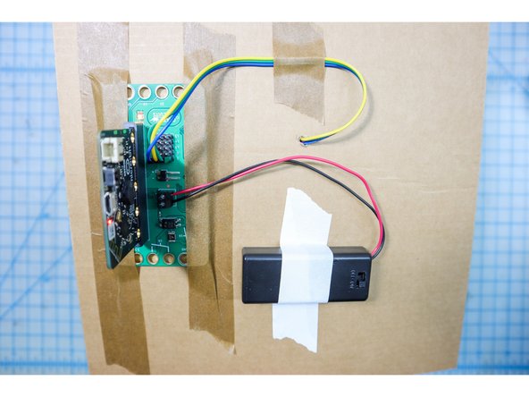 Tape the Bit Board to the back of the project and insert the micro:bit.