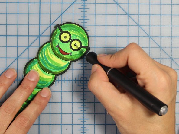 Cut a slit across the center of the eye, where the horizontal line is.