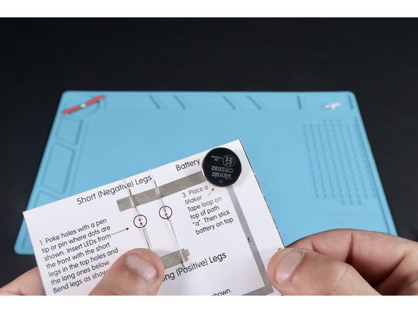 Stick your battery (positive side up) onto the tape loop.