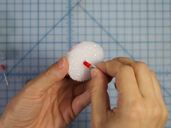 Press the LED through the styrofoam eye where you made the hole before.