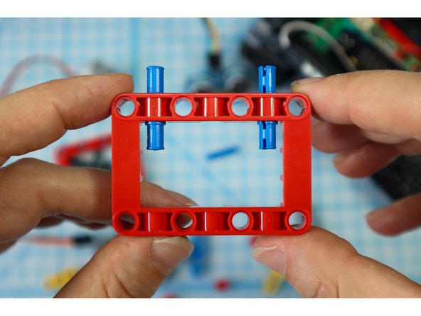 From the inside of the frame,  insert the blue pins &quot;long-side-in-first&quot; as shown.