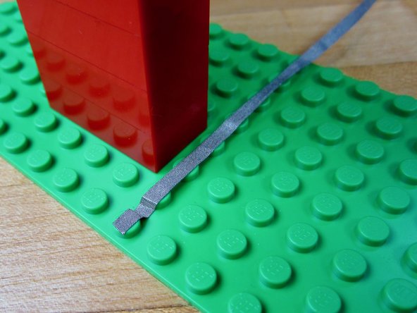 Run a long line of tape from the far left LED to Pin 2 on the Robotics Board.