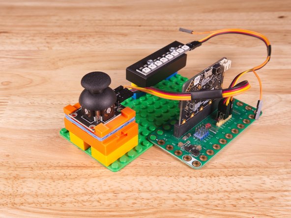 We attached two 2x4 LEGO Bricks to the bottom of the 3D printed holder to allow it to snap onto the LEGO Baseplate a bit easier.