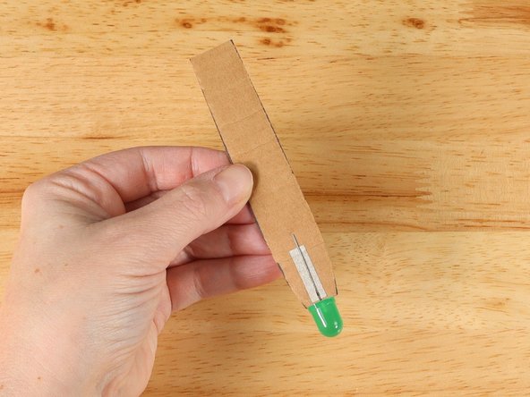 The Long Leg (Positive +) should be on the front of the handle and the Short Leg (Negative -) should be on the back side of the handle.