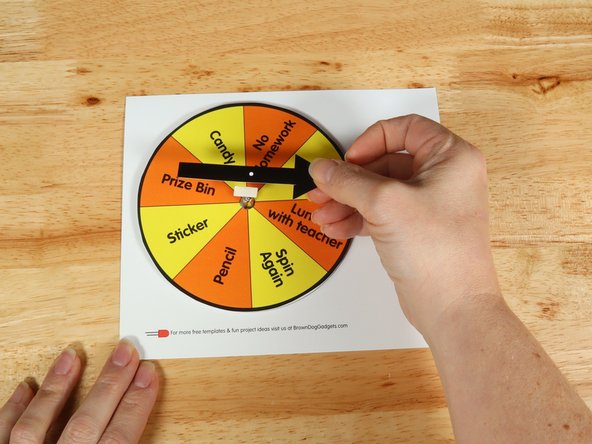 Add another square of double-sided tape onto the shaft of the motor, and then stick the arrow to it.