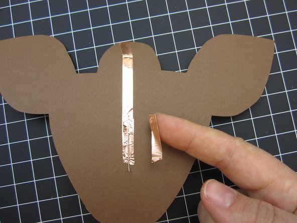 Position your LED legs over each of the lines of tape.