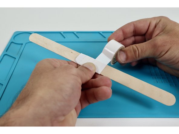Use masking tape and join your two jumbo craft sticks to effectively create one long handle.