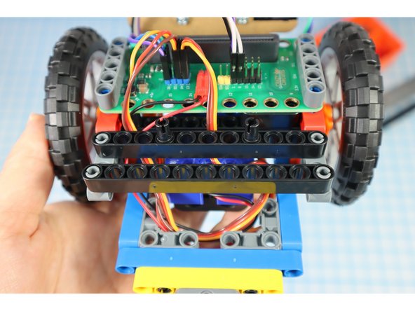 Add two black beams to the rear supports as shown.