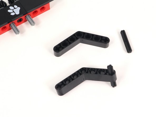 Insert a 3 stud long black axle into the plus-shaped hole at the end of a black bent beam. You will need two of these.