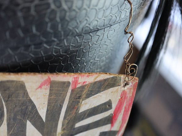 Attach it to the cauldron with wire.