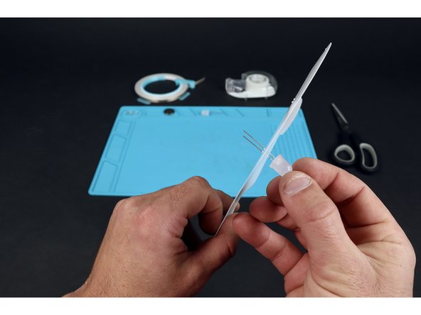 Thread each of your two LEDs through these two sets of two holes. Orient the LEDs so that the long legs  go through the holes marked &quot;L&quot; and the short LED legs go through the holes marked &quot;S&quot;.