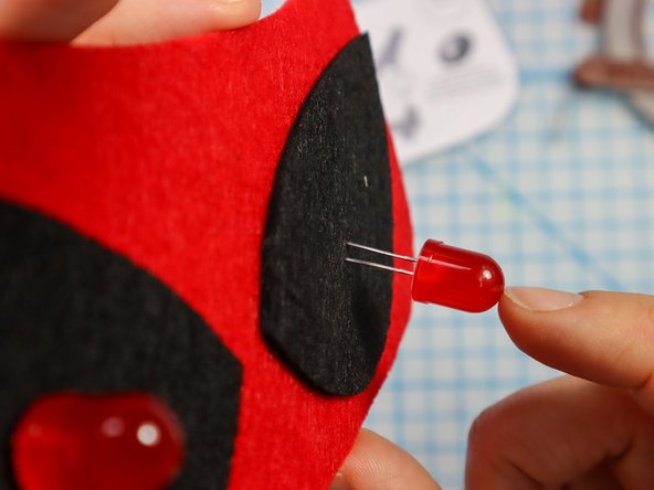 Insert each LED through the holes with the longer, positive leg in the top hole.