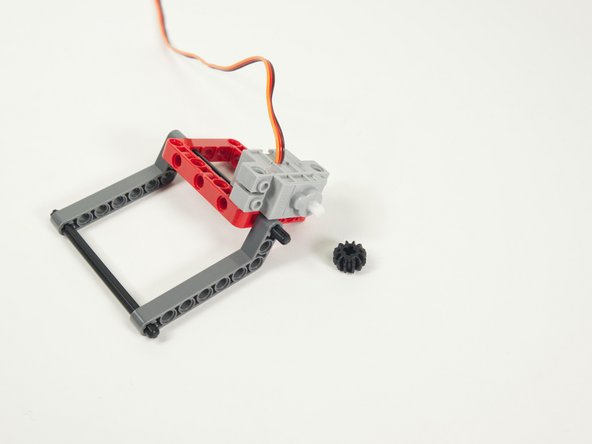 Next we'll press the small gray gear onto the servo shaft.