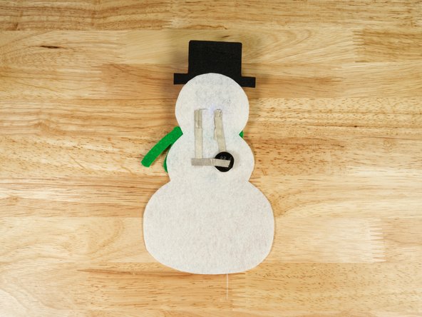 You can easily safety pin your Snowman to your clothing, or hang it on a Christmas tree as an ornament.