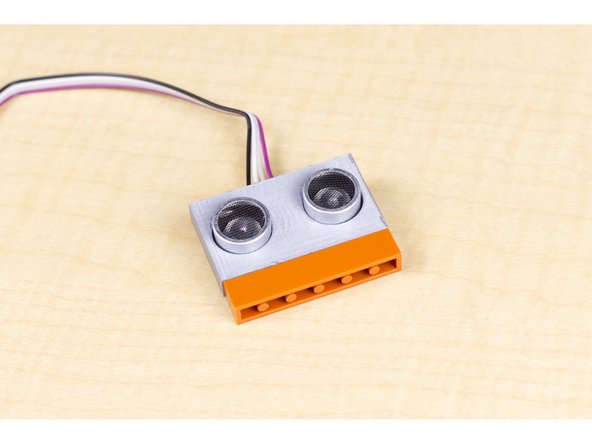 We 3D printed a LEGO-compatible holder for the ultrasonic sensor. You can find the file on Thingiverse if you want to use it: https://www.thingiverse.com/thing:317100...