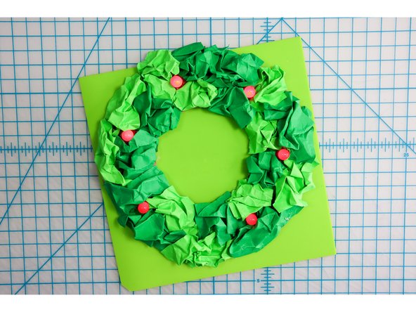 I glued the crumpled rectangles in place all around the wreath, alternating between shades of green.