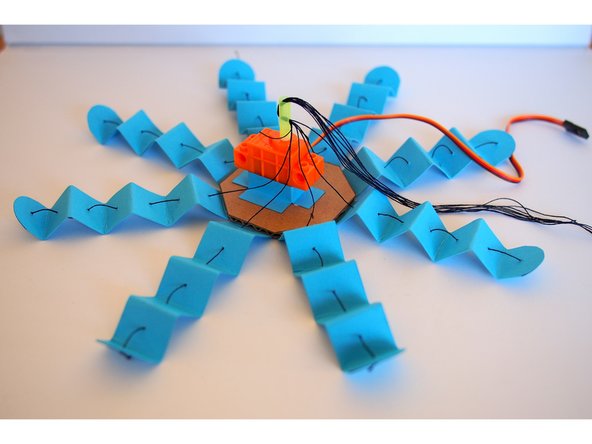 Push the straw to the servo shaft, making  sure it's snug (if it's loose, the shaft will just spin inside the straw without turning the straw itself)