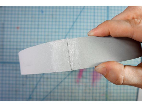 Use rubber cement to connect the ends of the long strip to make a circle.