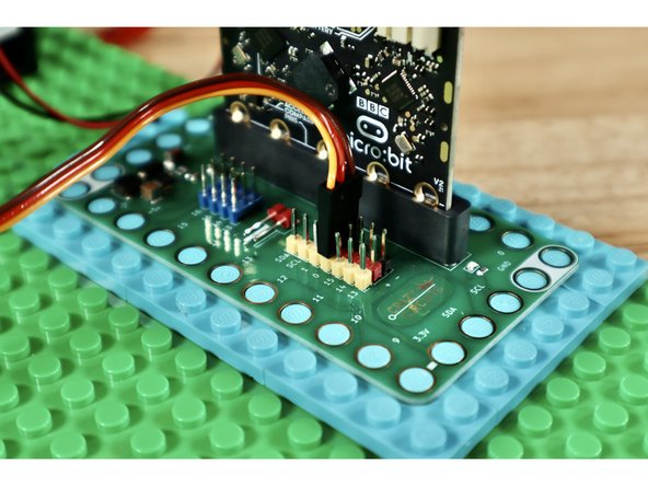Connect the ribbon cable from the servo to Pin 0 on the Bit Board making sure to orient the plug as shown in slide 1.