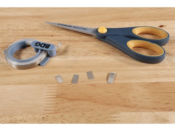 Measure and cut 4 small pieces of Maker Tape.