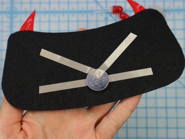 Place the battery on top of the Maker Tape as shown, and add the &quot;V&quot; shaped piece on top.