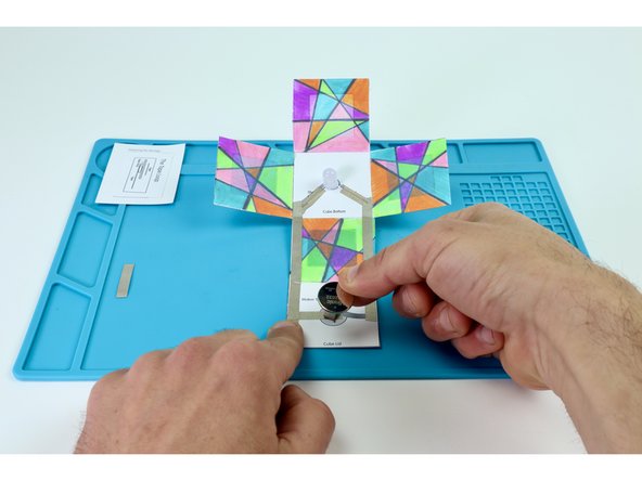 Place your battery positive (+) side UP atop the tape loop.