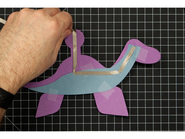 The tape should wrap around the round part to the front side of the Plesiosaurus.