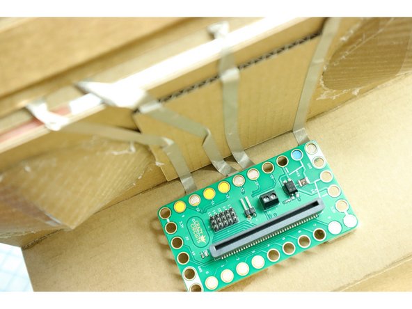 Place the Maker Tape over the appropriate LEGO stud for each piece, trim it, then place the Bit Board on top.