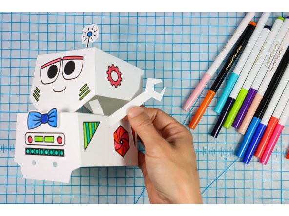 Insert the arms through the slits in the side.