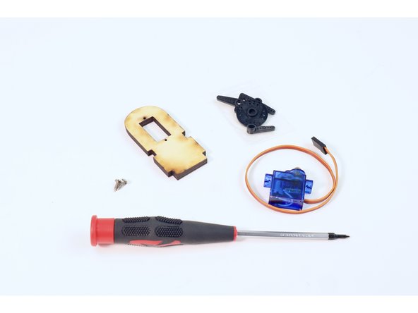 Using the wooden servo plate shown, and the two matching small screws found in the last servo bag, mount the remaining servo  using your Phillips head screwdriver.