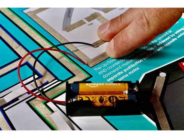 Remove battery pack from the Double Pole Double Throw Switch Circuit. Using the third photo as a reference connect each of the battery pack wires to the appropriate paths on this new circuit template with small pieces of Maker Tape. They may still be reuse-able from the previous circuit but it's fine to cut and use new ones.