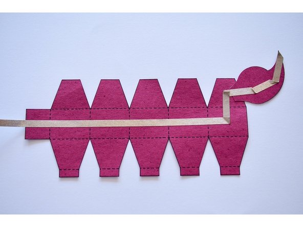 Tape the rest of the Maker Tape along the length of the tail as shown.