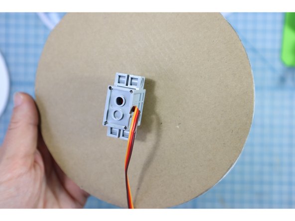 Place the motor through the hole from the back and attach the pupil on top as shown.