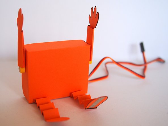 Slide the arms onto the LEGO axle mounts.