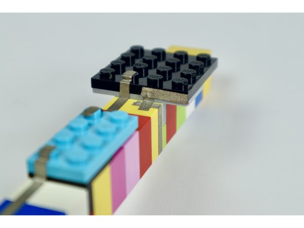 If you completed these last 4 small tape paths correctly, the end of your last segment should reach the first LEGO stud of the 4x4 LEGO plate with one stud-worth of space between it and the neighboring path.