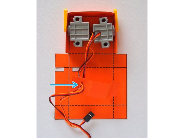 Thread the servo wires through the cutout in the servo holder.